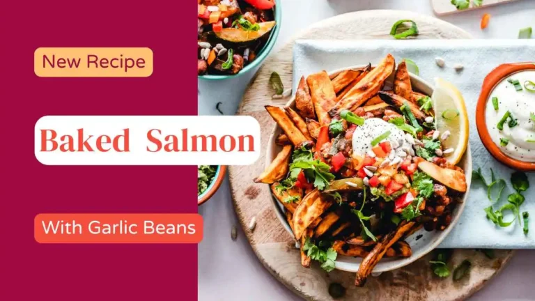Baked salmon fillet with sautéed garlic green beans on a ceramic plate.

